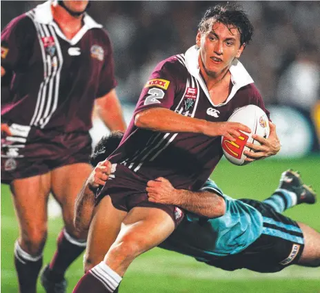  ??  ?? Maroons debutante Mat Rogers stretches the defence of Brad Fittler in Origin I in 1999 at Suncorp Stadium; is dragged down by Ryan Girdler (below left); and celebrates with teammates (below right) after kicking the late field goal for a 9-8 win.