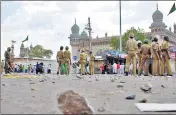  ?? REUTERS FILE ?? Policemen stand guard at the site of a blast in front of Mecca Masjid in Hyderabad on May 18, 2007.