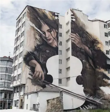  ?? ?? Ode to music … Spanish street artist SFHIR’S ‘Fene’s Violonchel­ist’ won the Best Mural of the World during the Perla Mural Fest in August 2023.