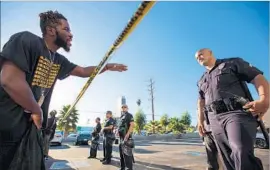  ??  ?? MONIQUE MORGAN, top, in blue shirt, pleads with officers to let her see her son after he had been shot. Above, a man in the crowd confronts an officer.