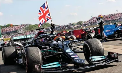  ?? ?? Lewis Hamilton celebrates winning the 2021 British Grand Prix at Silverston­e. This year’s race is expected to attract more than 400,000 fans across the three days. Photograph: Pool via FIA/PA