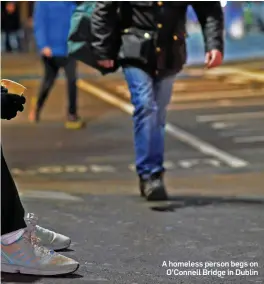  ??  ?? A homeless person begs on O’Connell Bridge in Dublin