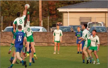  ??  ?? Baltinglas­s midfielder Sean Doody gets his fist to the ball.