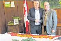  ?? CONTRIBUTE­D PHOTO ?? Premier of P.E.I. Dennis King presents Alan Mulholland with the flag of Prince Edward Island.