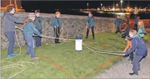  ?? 25_c42scouts0­1 ?? Teamwork is vital to scouting: here scouts try to remove a barrel from a minefield with one rope.