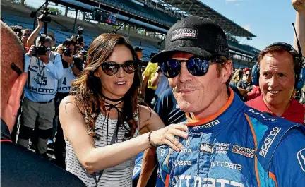  ?? PHOTO: PHOTOSPORT ?? Scott Dixon is congratula­ted by wife Emma Davies-Dixon after claiming pole position for the Indianapol­is 500. Later that day, he was robbed.