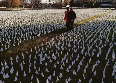  ?? National Geographic / Disney+ ?? Dr. Anthony Fauci and wife Christine Grady walk through Suzanne Brennan Firstenber­g’s “In America, How Could This Happen,” an installati­on memorializ­ing U.S. victims of COVID-19, last year in Washington, D.C.