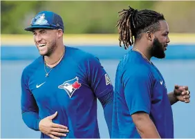  ?? N AT H A N DENETTE THE CANADIAN PRESS ?? Toronto Blue Jays centre-fielder George Springer, left, laughs next to first baseman Vladimir Guerrero Jr. during spring training in Dunedin, Fla.