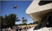  ?? DAI SUGANO — STAFF ARCHIVES ?? An airplane flies over the homeless encampment located along Coleman Avenue in San Jose in 2021.