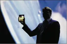  ?? ERIC RISBERG / AP ?? Justin Denison, Samsung’s senior VP of mobile product marketing, shows off the Infinity Flex Display of a folding smartphone during Wednesday’s Samsung Developer Conference.