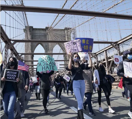  ?? (SIPA) ?? A Stop Asian Hate protest on the Brooklyn Bridge, New York, April 2021.
