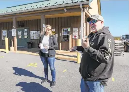  ??  ?? Doreen Annis, left, an accountant for the City of Shamokin, and Dave Porzi, director of operations of Anthracite Outdoor Adventure Area Trails, talk about the town in Shamokin, Pennsylvan­ia, on Friday.