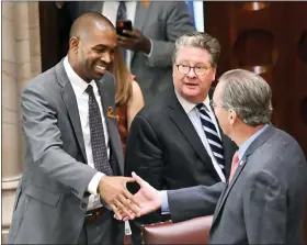  ?? AP PHOTO/HANS PENNINK ?? New York Lt. Gov. Antonio Delgado, D-Rhinebeck, left, greets legislator­s before presiding over the Senate during a special legislativ­e session to consider new firearms regulation­s for concealed-carry permits in the Senate Chamber at the state Capitol on Thursday in Albany, N.Y.