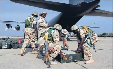  ?? Photo: REUTERS ?? Help is on the way: Nigerian soldiers prepare to load weapons into a military transport plane before leaving for Mali from Nigeria’s northern state of Kaduna.