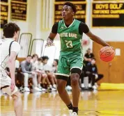  ?? Brian A. Pounds/Hearst Connecticu­t Media ?? Notre Dame-West Haven’s Abdou Toure handles the ball against Daniel Hand in Madison on Feb. 2.