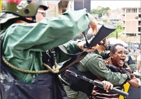  ?? AFP ?? The Venezuelea­n National Guard clashes with citizens protesting against the severe food and medicine shortages in Caracas on June 8.