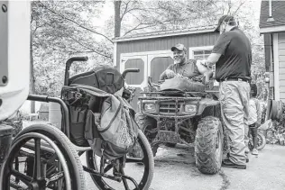  ?? Photos by Mark Mulligan / Staff photograph­er ?? Chambers County paramedic Danny Burke administer­s the first dose of the Moderna COVID-19 vaccine to Grady Carrington in Hankamer as part of a mobile vaccinatio­n service.