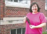  ?? (The Tribune/Tammy Real-McKeighan) ?? Sally Klein of Wahoo, Neb., shows the length of some of the hair she’s donating to Locks of Love. Over the past 15 years, Klein has donated hair that’s made into wigs to help cancer patients, burn victims and others.