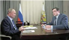  ?? /Reuters ?? On the table: Russia’s President Vladimir Putin meets Gleb Nikitin, the governor of Nizhny Novgorod region in Sarov, who posted a picture of a fire truck beside the Norsi refinery.