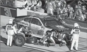  ?? AP/DAVID GRAHAM ?? Crew members work on Dale Earnhardt Jr.’s car during Sunday’s Daytona 500. Earnhardt’s race ended after 106 laps resulting in a 37th-place finish.