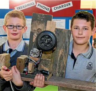  ?? PHOTO: MURRAY WILSON/STUFF ?? William Giles and Ben Richards built a treadmill-powered device charger.