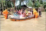  ?? PIC/PTI ?? National Disaster Response Force (NDRF) Personnel rescue people from a flood affected village, in Kamrup district, on Monday