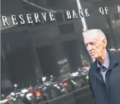  ??  ?? A man walks past the Reserve Bank of Australia sign in Sydney on June 6. Australia’s central bank held interest rates at a record low 1.50 per cent on June 6 ahead of quarterly economic growth data analysts expect to come in weak. — AFP photo