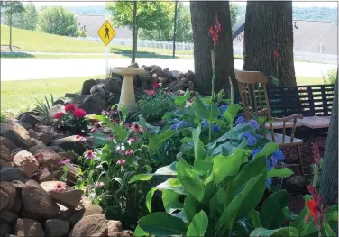  ?? PHOTO BY SHIRLEY WALTON ?? Dan Lindley found a rocking chair in the trash, fixed it, and put it in the garden. Hence the name, the “Rocking Rock Garden.”