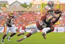  ?? JOHN MCDONNELL/THE WASHINGTON POST ?? Redskins cornerback Josh Norman foils the Bucs’ Shaun Wilson by pulling in an intercepti­on at the goal line in the first quarter.