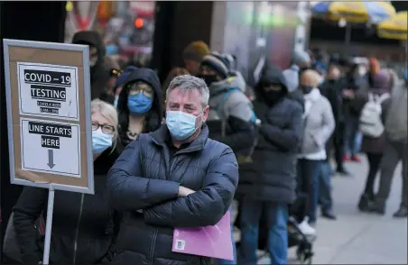  ?? SETH WENIG — THE ASSOCIATED PRESS FILE ?? People wait in line at a COVID-19 testing site in Times Square, New York, Dec. 13, 2021. Scientists are warning that omicron’s lightning-fast spread across the globe practicall­y ensures it won’t be the last worrisome coronaviru­s variant. And there’s no guarantee the next ones will cause milder illness or that vaccines will work against them.