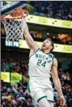  ?? ?? Milwaukee Bucks guard Pat Connaughto­n dunks against the Utah Jazz during the second half of an NBA basketball game in Salt Lake City. (AP )