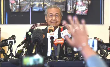  ??  ?? Dr Mahathir answers questions from the media during the press conference at the Perdana Leadership Foundation. — Bernama photo