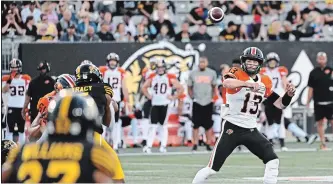  ?? JON BLACKER THE CANADIAN PRESS ?? B.C. Lions quarterbac­k Mike Reilly throws the ball downfield against the Hamilton Tiger-Cats during first half CFL football game action in Hamilton on Saturday. Reilly was a full participan­t at B.C.’s practice Monday.