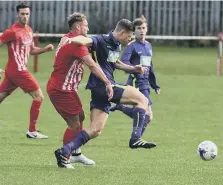  ??  ?? Ryhope CW (red and white) battle against Guisboroug­h last Saturday.