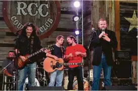  ?? Courtesy of Redneck Country Club ?? Michael Berry, far right, speaks on stage at the Redneck Country Club during its third-anniversar­y party earlier this month.