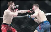  ?? Frank Franklin II Associated Press ?? KHABIB NURMAGOMED­OV, left, beats replacemen­t fighter Al Iaquinta in the UFC 223 main event.