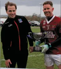  ??  ?? Cromane captain John Michael Foley receiving the Junior Men’s Cup from Pádraig Ó Sé.