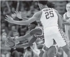  ?? THE ASSOCIATED PRESS ?? UCLA guard Aaron Holiday tries to work out of a trap by Kentucky forward PJ Washington and another player during the second half of Saturday’s game in New Orleans. UCLA won 83-75.