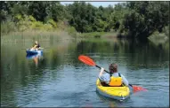  ?? BEA AHBECK/NEWS-SENTINEL ?? Debbie Skaggs and her son Michael paddle kayaks down the Mokelumne River at Lodi Lake in 2016. The City of Lodi’s Parks, Recreation and Cultural Services department is offering a three-day morning camp at the lake.