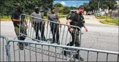  ?? Chandan Khanna AFP/Getty Images ?? IN ATLANTA, officers erect barricades outside the jail in anticipati­on of arrests in the case by Friday.
