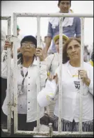  ?? AP PHOTO ?? Women kneel during Mass celebrated by Pope Francis in Villavicen­cio, Colombia.