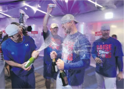  ?? JONATHAN DANIEL / GETTY IMAGES ?? The Chicago Cubs celebrate after a 5-0 win over the Dodgers Saturday night, clinching the team’s first National League pennant in 71 years.