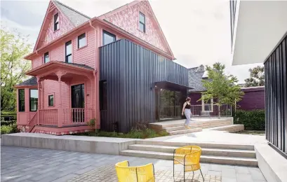  ?? JANIS NICOLAY ?? NOW: The modern addition to the rear of the old, Victorian-era house creates a stark contrast while also linking with the new building’s design theme. The home’s five suites serve multiple generation­s.