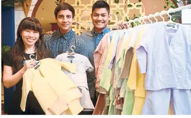  ??  ?? Razlan (far right) got his friends Chan (far left) and Ranesh to design baju Melayu that his son would be comfortabl­e wearing. — SIA HONG KIAU/The Star