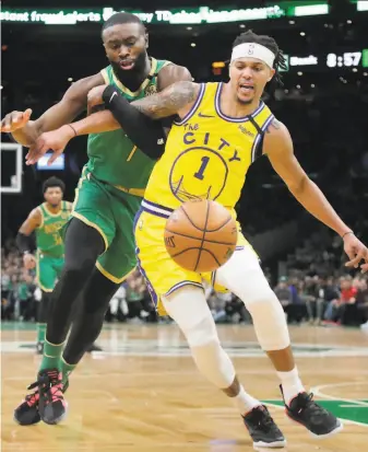  ?? Elise Amendola / Associated Press ?? Boston guard Jaylen Brown (left) and Warriors guard Damion Lee jockey for a loose ball during the Celtics’ runaway win at TD Garden. Golden State’s record fell to 1039.