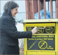  ?? NIKKI SULLIVAN/CAPE BRETON POST ?? Christine Porter, executive director of the Ally Centre of Cape Breton, opens the safe needle drop off kiosk located outside their office on Bentinck Street in Sydney. The kiosks are a harm reduction strategy that helps reduce the amount of improperly...