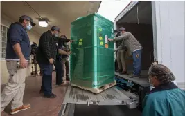  ?? KARL MONDON — BAY AREA NEWS GROUP VIA AP ?? Freezers designated for storing the COVID-19 vaccine arrive at San Mateo Medical Center on Wednesday. The County of San Mateo is expecting an initial 5,850 doses of the Pfizer vaccine which must be safely stored in ultra-cold freezers to remain effective.