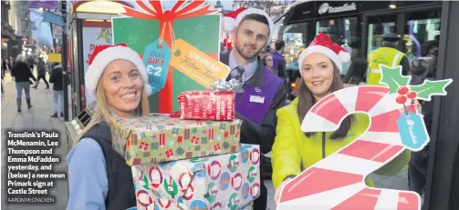  ?? AARON McCRACKEN ?? Translink’s Paula McMenamin, Lee Thompson and Emma McFadden yesterday, and (below) a new neon Primark sign at Castle Street