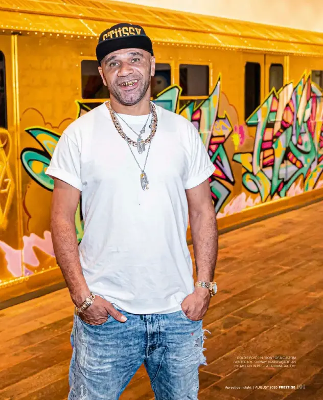  ??  ?? GOLDIE POSES IN FRONT OF A CUSTOM PAINTED NYC SUBWAY TRAIN FAÇADE, AN INSTALLATI­ON PIECE AT AURUM GALLERY