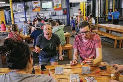  ?? Photos by Jon Shapley / Staff photograph­er ?? Lesli Buihner, left, and John McDougall mark their bingo cards while playing at the brewery.